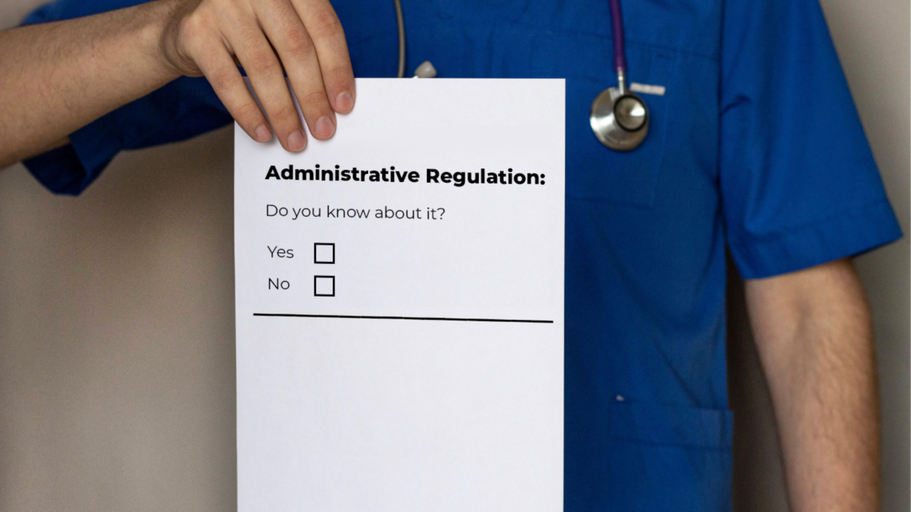 Man holding up a paper form asking if you know about administrative regulation