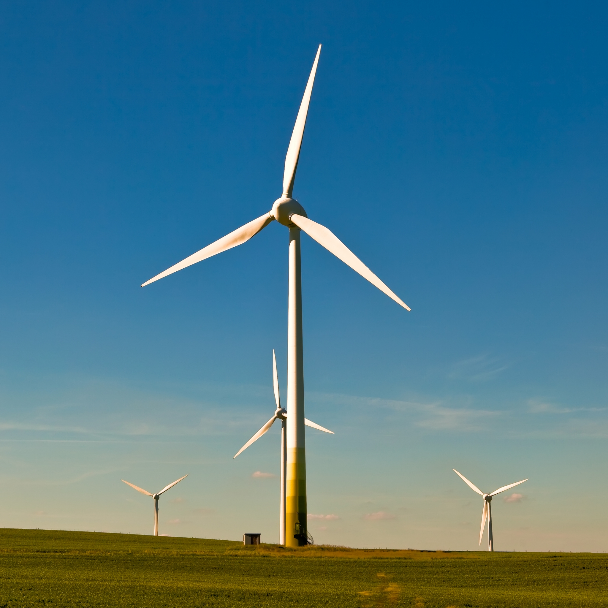Four large wind turbines in a field