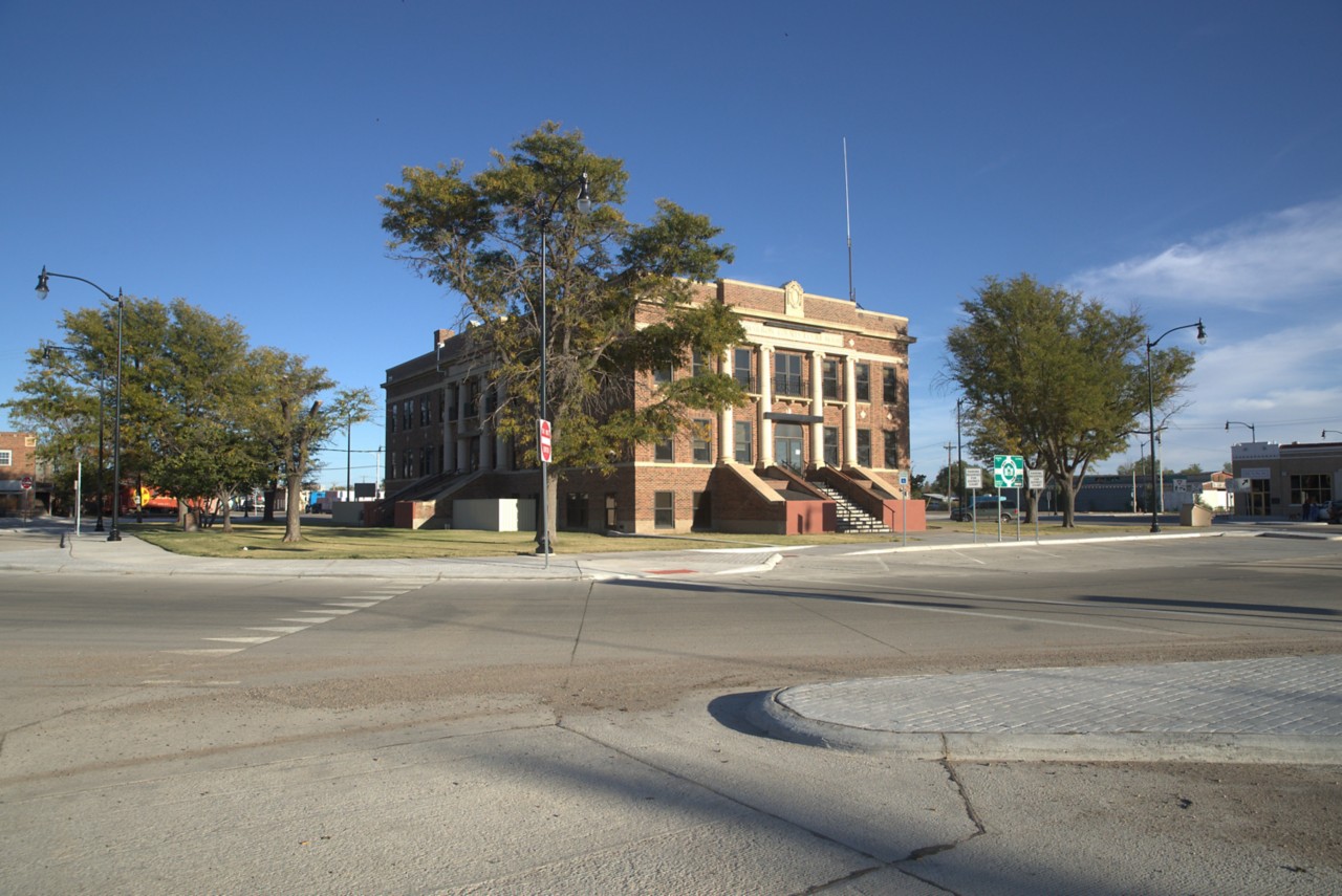 Cimarron County Courthouse in the Boise City square, circled by new highway pavement, sidewalks and parking spaces 