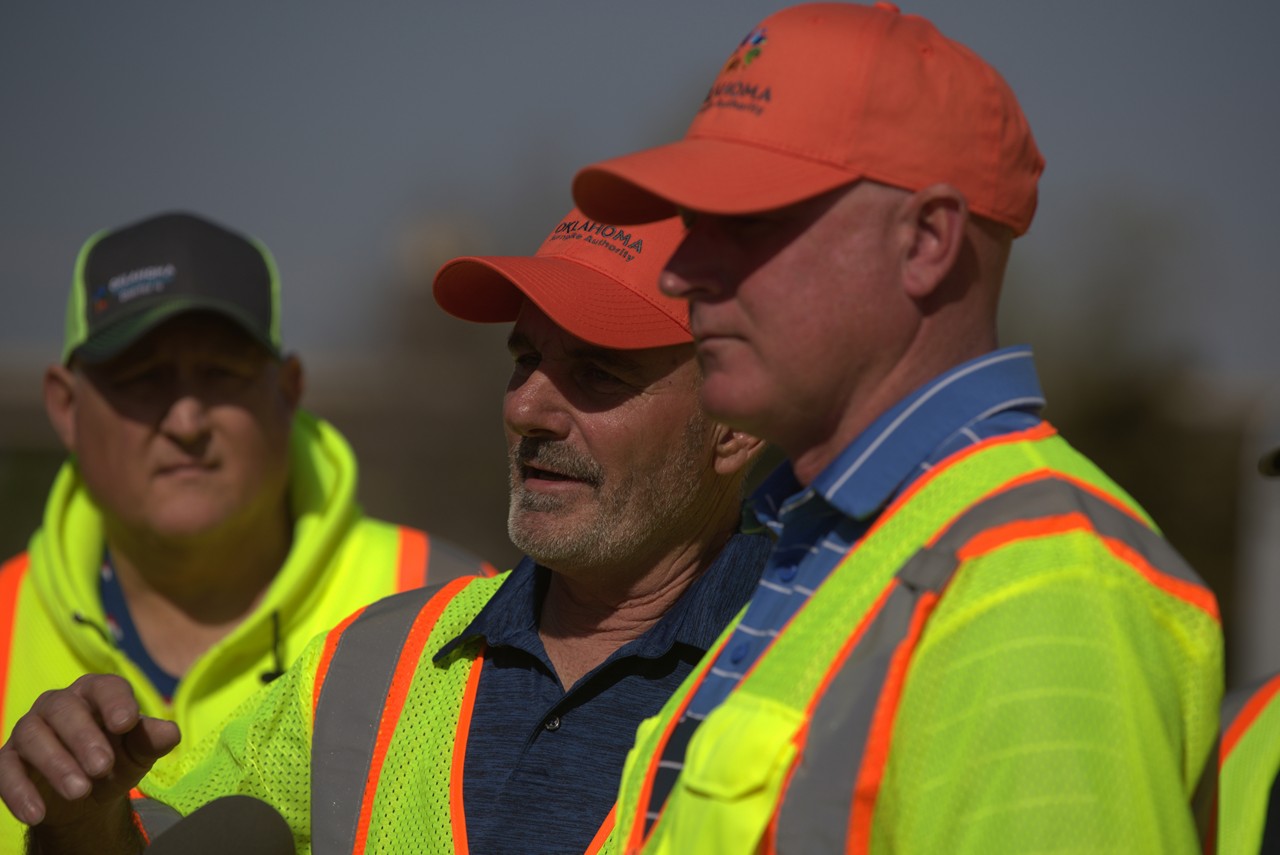 Oklahoma Department of Transportation maintenance worker Darin Manley, left, and Oklahoma Turnpike Authority employees Kenny Baker, center, and Jeremy Smart, right, discuss recent near-miss crashes as work zone awareness weeks come to a close Friday. The workers urge drivers to put away distractions and slow down in work zones.