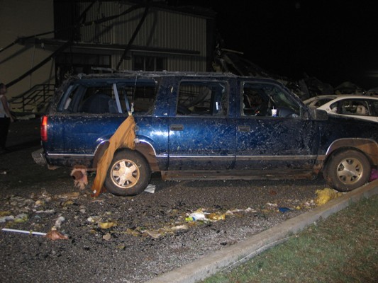 Debris surrounding blue SUV