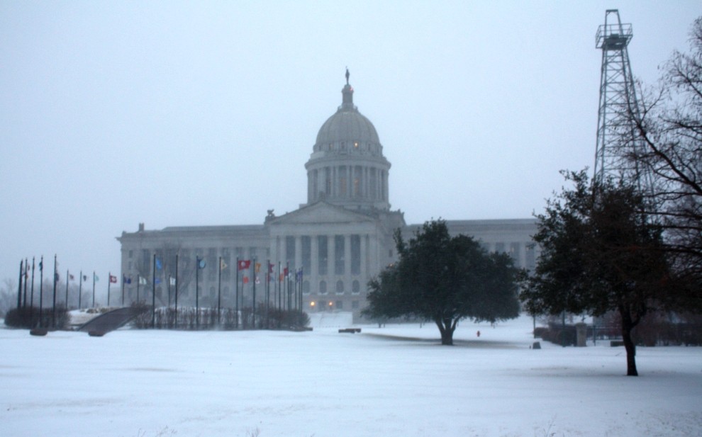 The grounds of the state capitol covered in snow. 