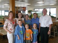 Ponca City Emergency Management Director Paula Cain, left, and McDonald's owner Clement Collogan, right, congratulate the four winners of the Eskimo Joe storm chaser t-shirt contest, which was part of the city's local McReady Oklahoma program