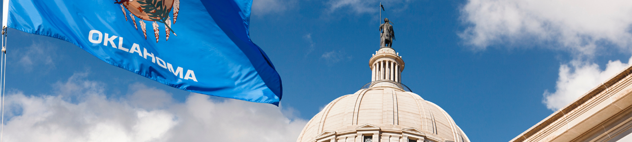 Oklahoma State Capitol dome, flag, and Guardian