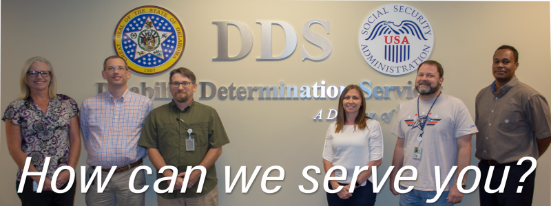 Six DDS employees stand in front of the DDS, Oklahoma Seal and SSA Seal. With 'How can we serve you?