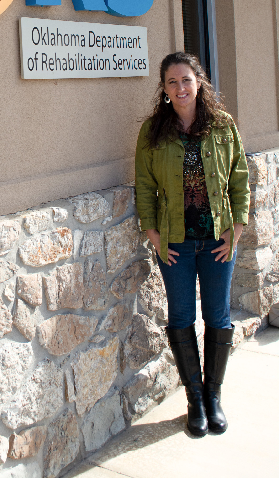 A woman poses for the camera outside of a DRS Office