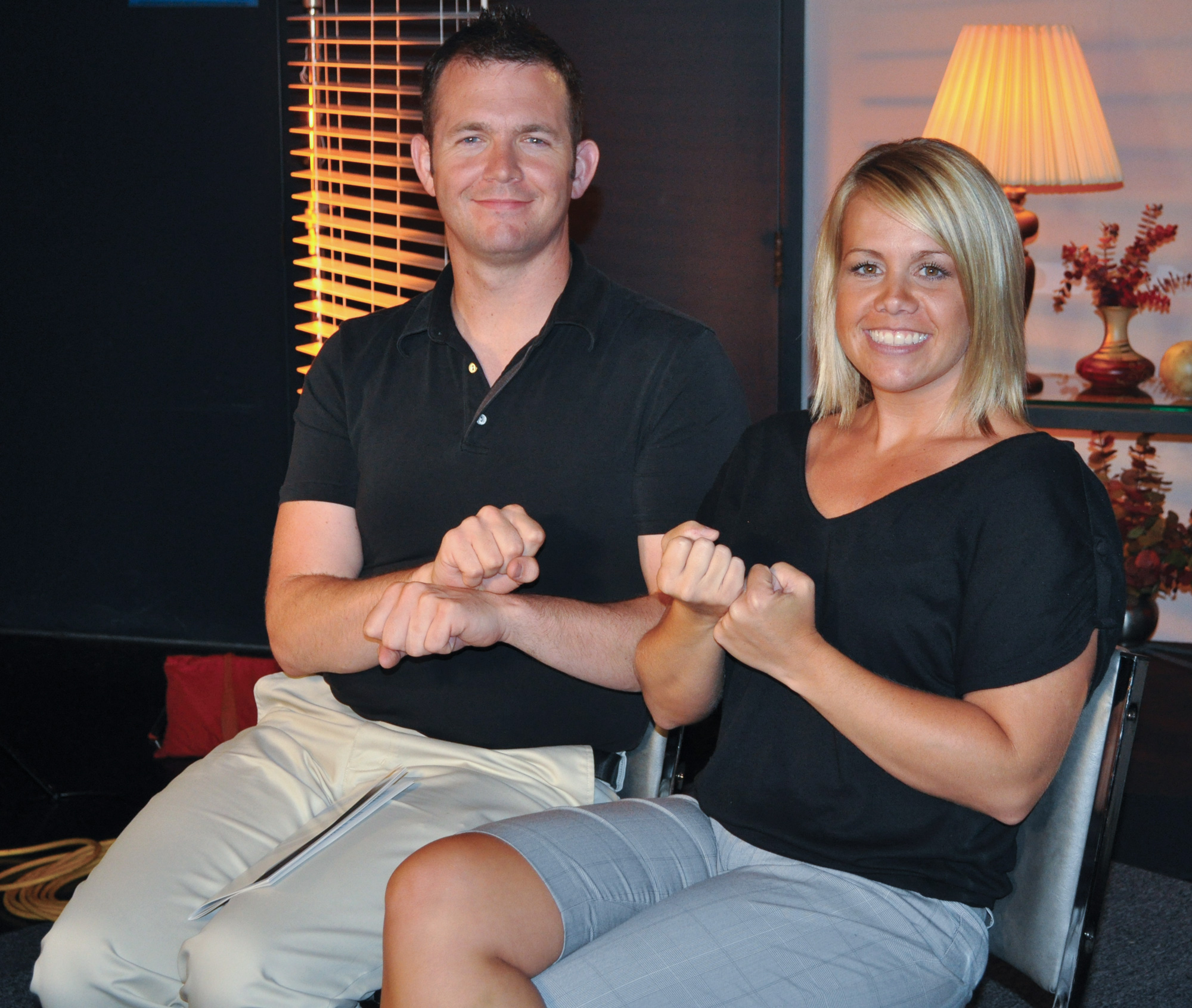 SDHH - Sign Language A man and woman seat showing signs for support and and service..
