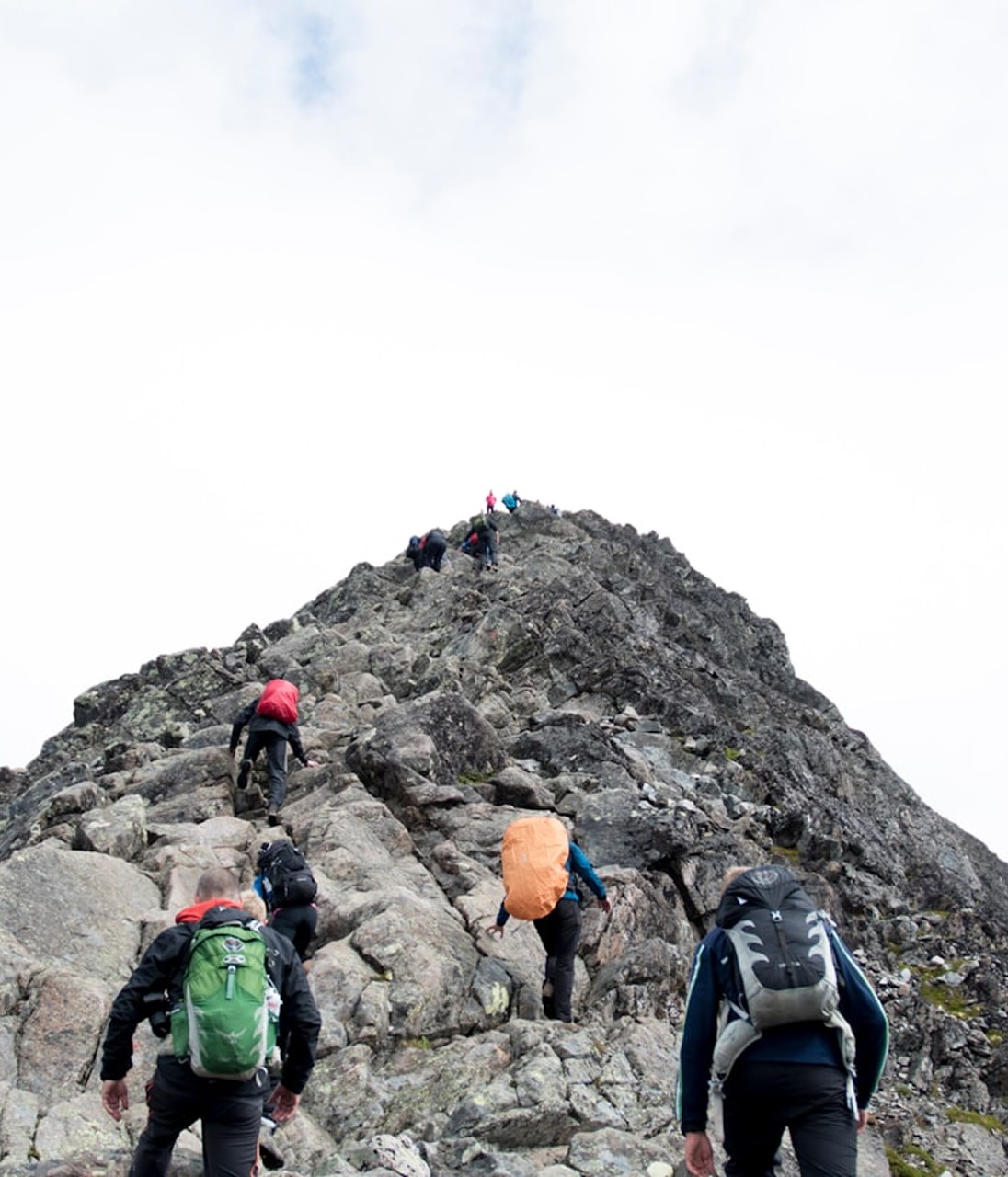 climbers hiking through mountain peak during daytime