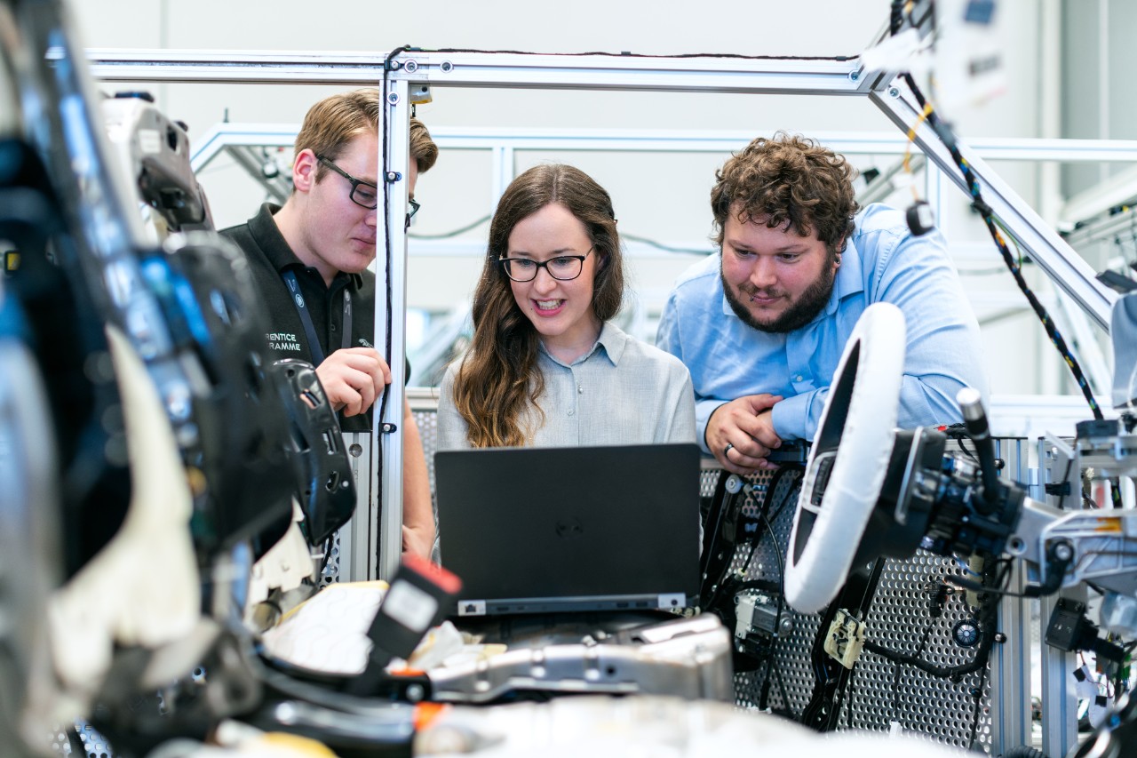 Engineering On the-job training - three people looking at laptop
