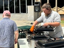Staff of Capital Assets Management preparing food during OMES Employee Appreciation Day.