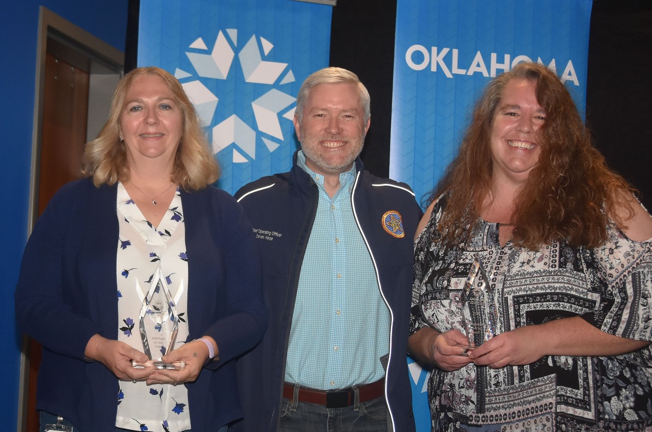Photo of managers of the year Lisa Raihl and Denise White with Chief Operating Officer and OMES Executive Director Steven Harpe