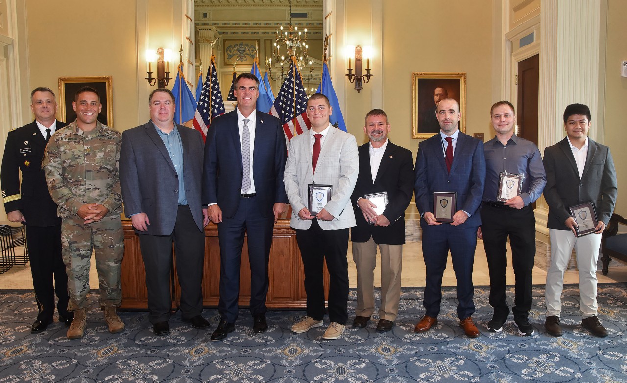 Pictured left to right: General Thomas Mancino; Major Dan Slusarchuk; Michael Toland, State Chief Information Security Officer; Oklahoma Gov. Kevin Sitt; Tyler Womack, OMES Security Engineer; John Phillips, OMES Hurt and Incident Response Manager; OMES Senior Security Engineer; Anton Bondarev, OMES Senior Security Engineer; Kim Baciles, OMES Senior Security Engineer.
