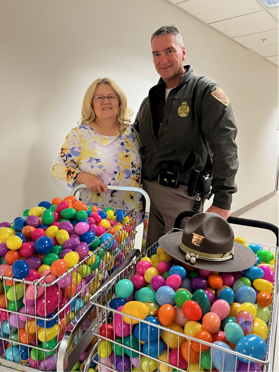 Lisa Whiteman and OHP trooper delivering Easter eggs.