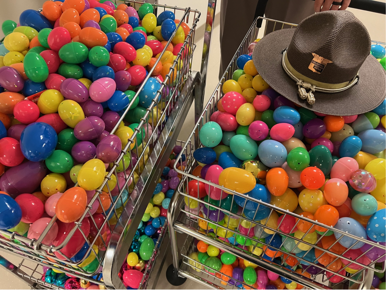 Two shopping carts filled with Easter eggs.