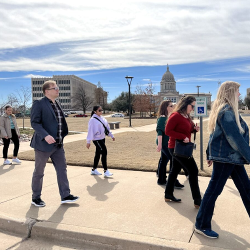 Group walking west toward Will Rogers Building Group walking west toward Will Rogers Building