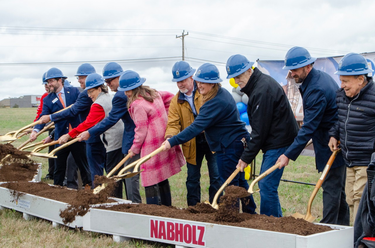 State leaders and Ronald McDonald House Charities staff shovel dirt at the ceremonial groundbreaking of the second RMHC location.