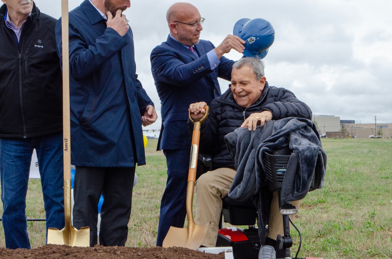 An attendee holds the shovel from the opening of the very first Ronald McDonald House in the United States.