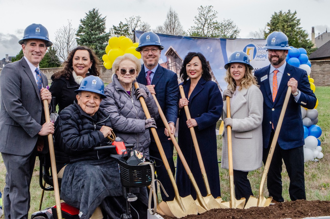Attendees gather for photos with the golden shovels previously used to break ground.