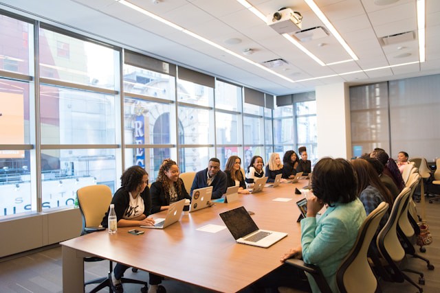 Decorative image of a full table in a meeting room
