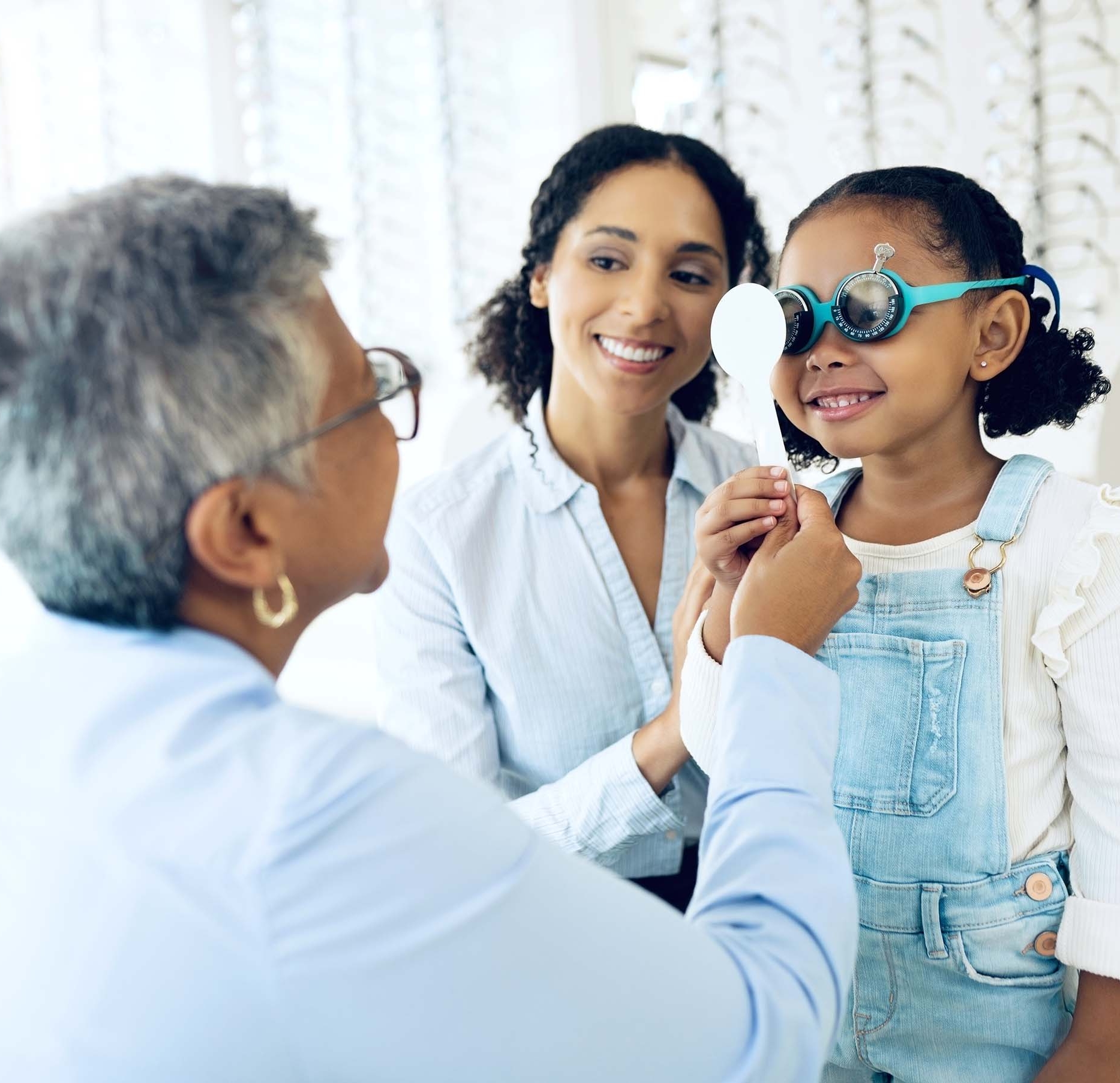 Decorative image of a child being examined by an optometrist