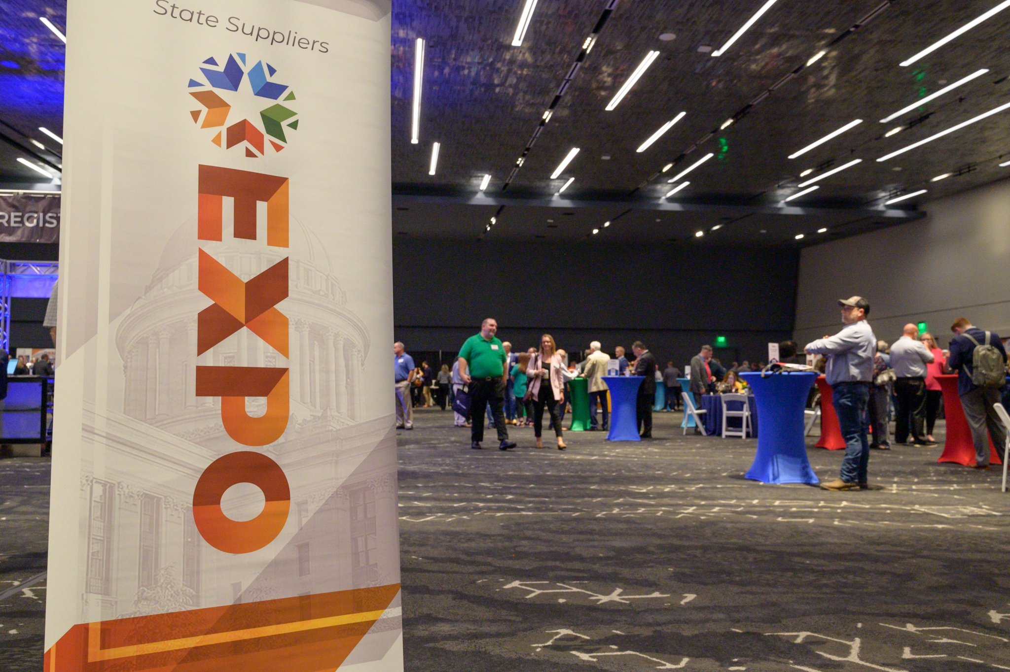 2023 Expo vertical banner with ballroom attendees walking in the background.