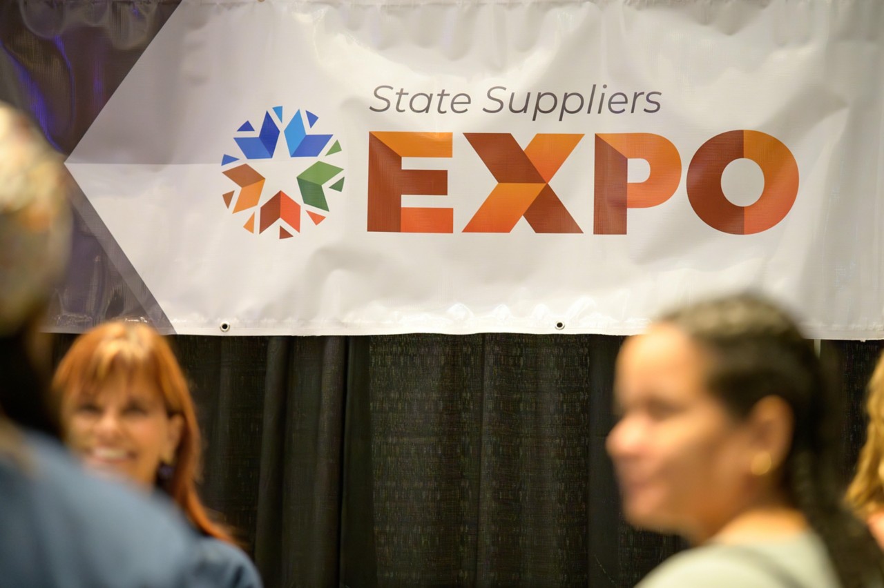 2023 State Suppliers Expo banner over the event welcome table.