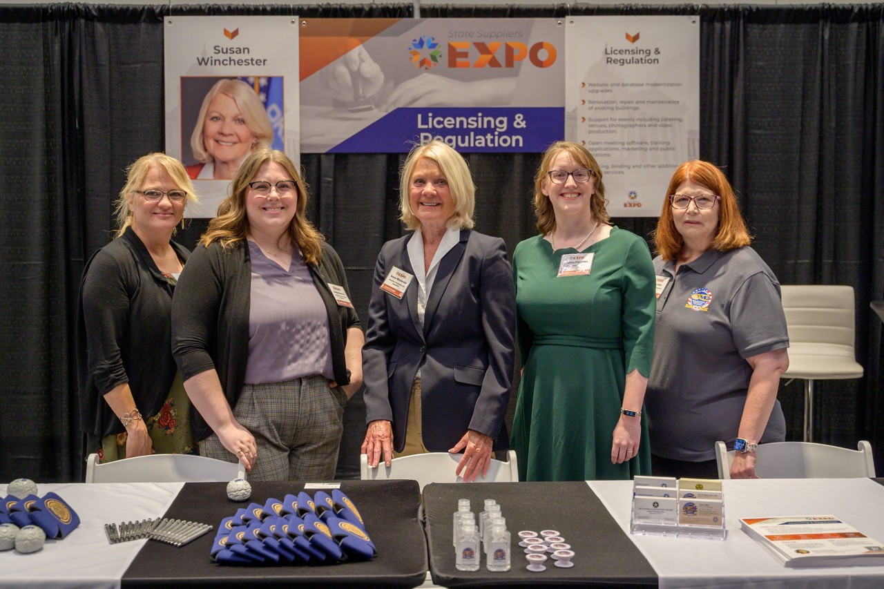 Secretary Susan Winchester and cabinet staff at the Licensing and Regulation booth.