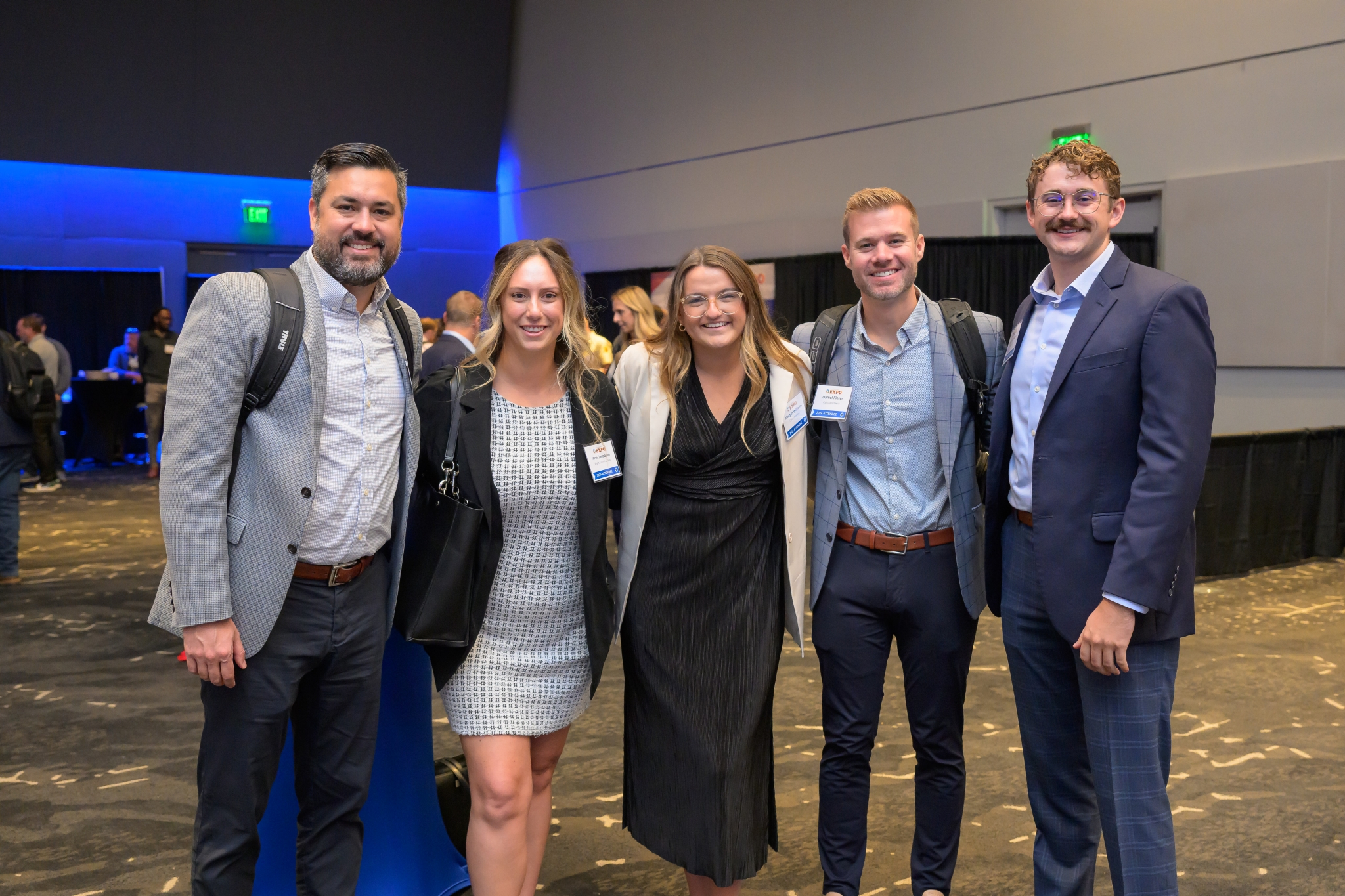 Five attendees smiling for a photo