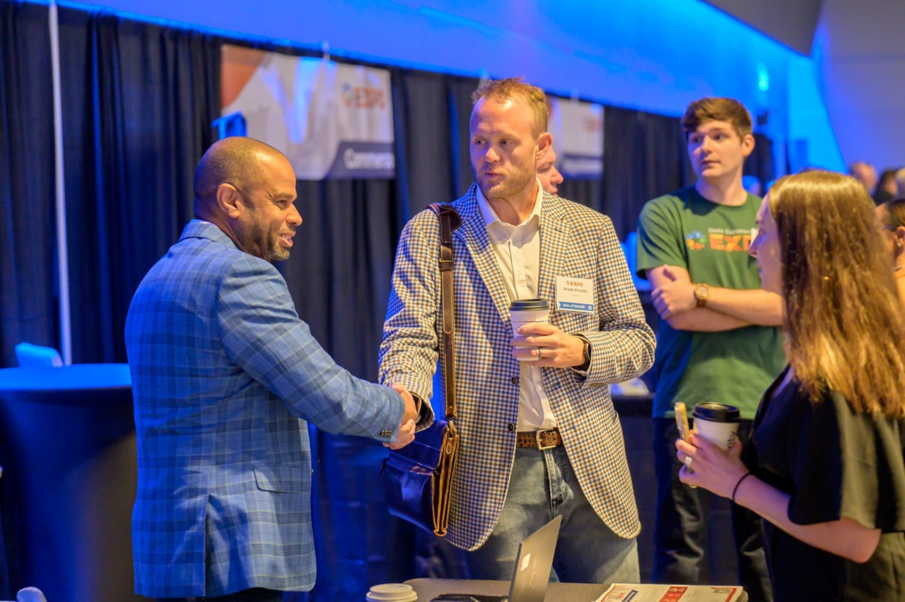 State CIO Joe McIntosh shakes hands with an attendee