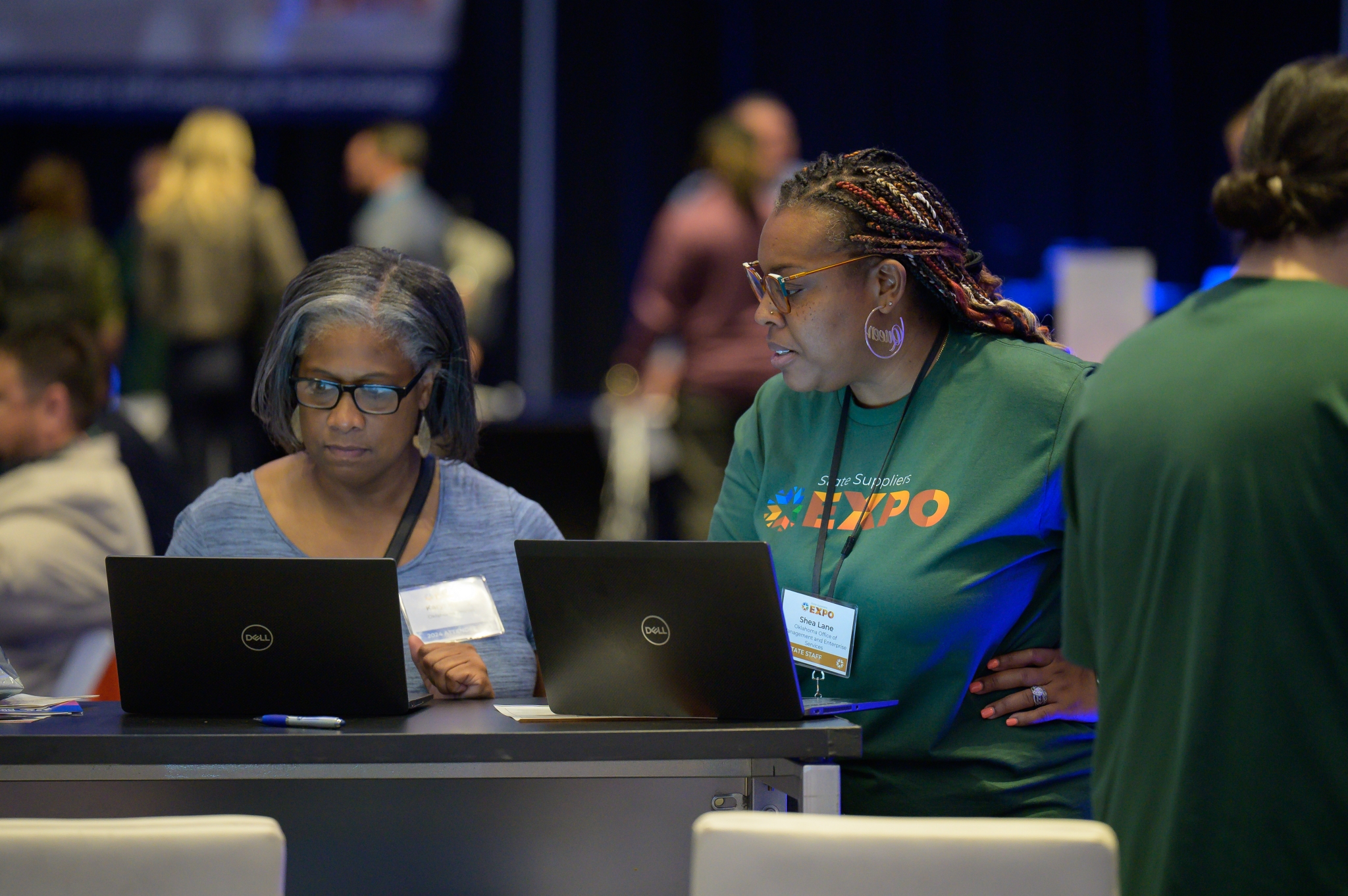 Registration Specialist Shae Lane assists attendee at Supplier Registration booth