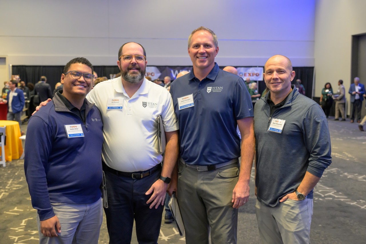 Four attendees stand together for a photo