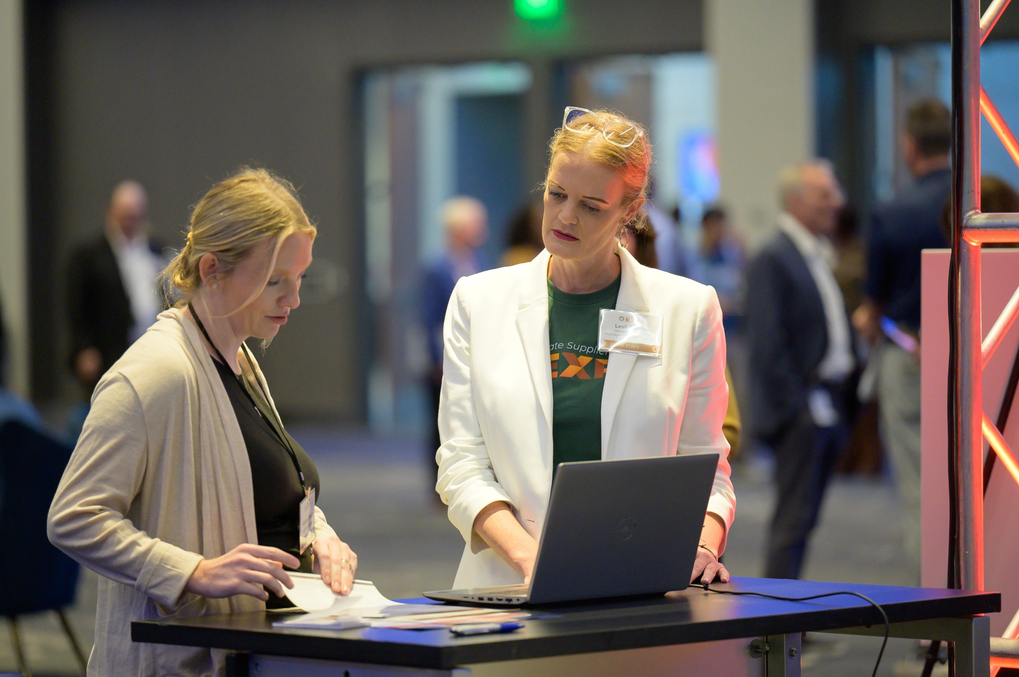 State staff member helps attendee sign up as a state bidder