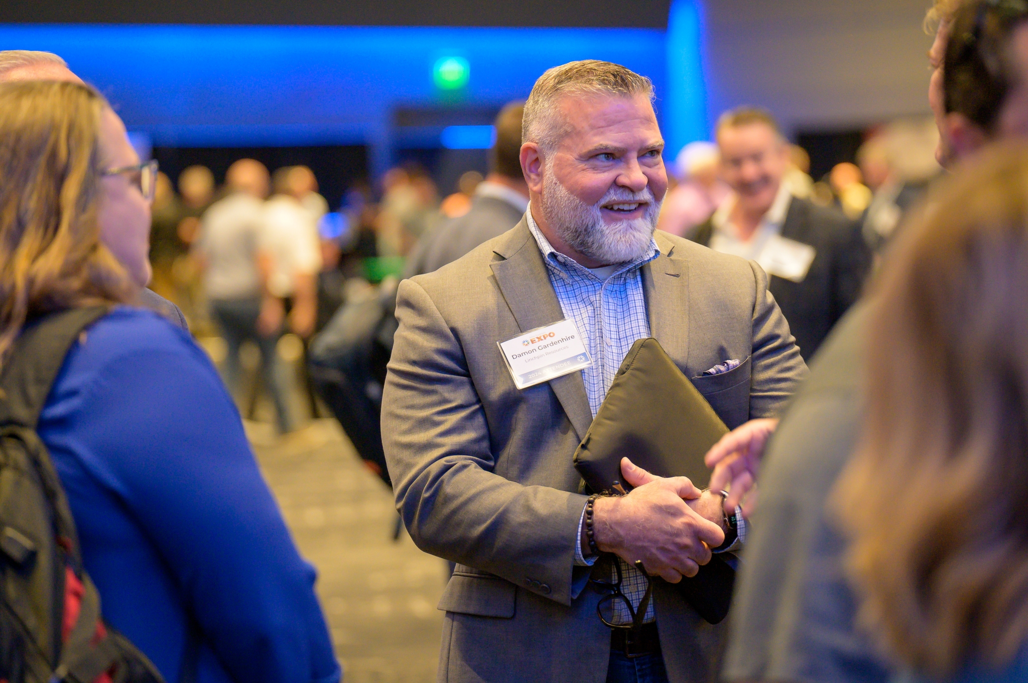 Attendee Damon Gardenhire smiling while chatting in the expo ballroom