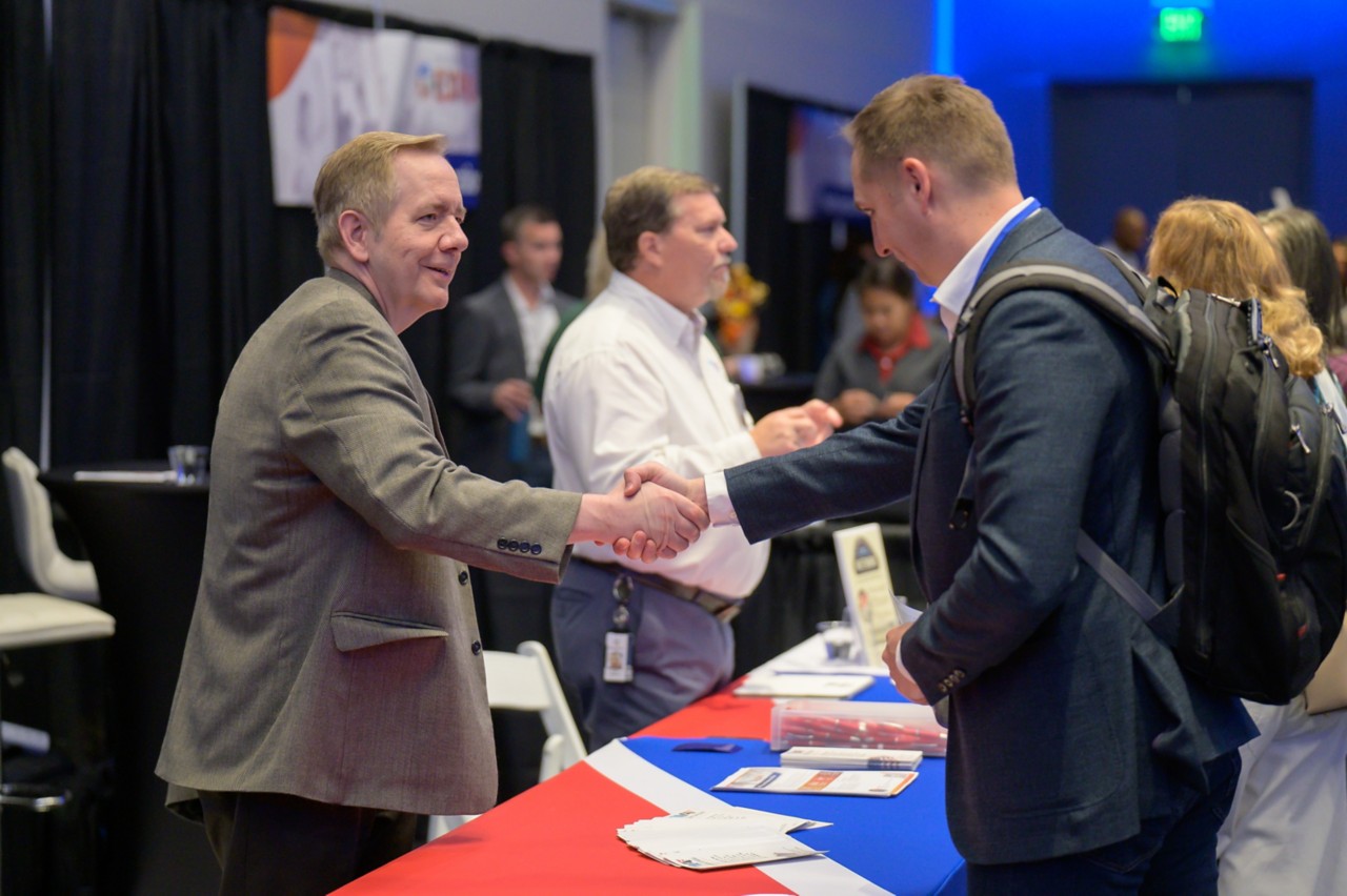 State staff shaking hands with an attendee