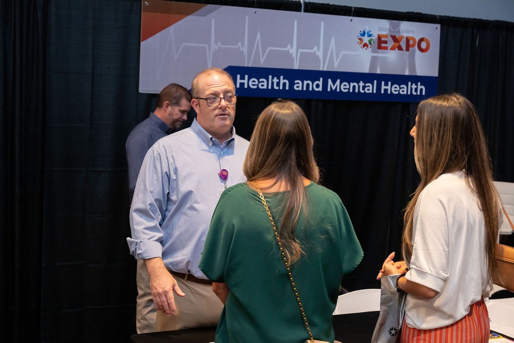 ODMHSAS employee interacting with suppliers at Health and Mental Health booth