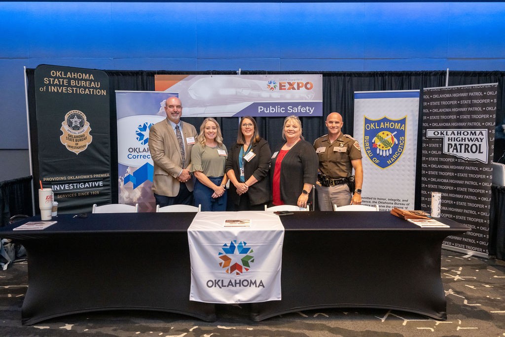 State staff smiling at Public Safety booth
